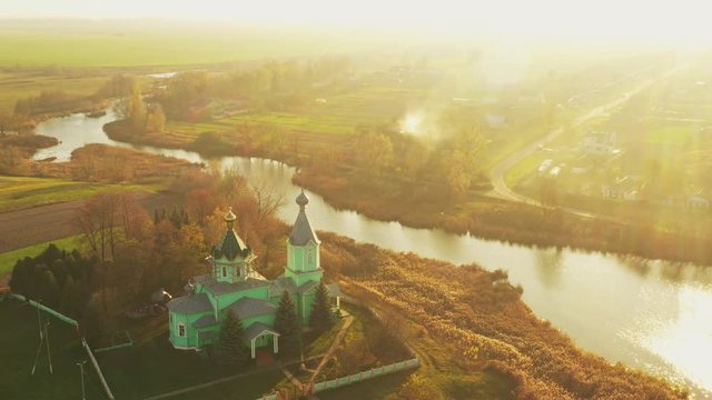 Krupets, Dobrush District, Gomel Region, Belarus. Aerial View Of Old Wooden Orthodox Church Of The Holy Trinity At Sunny Autumn Day