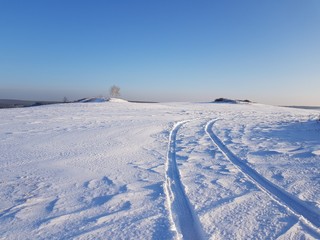 Snowy road in winter field