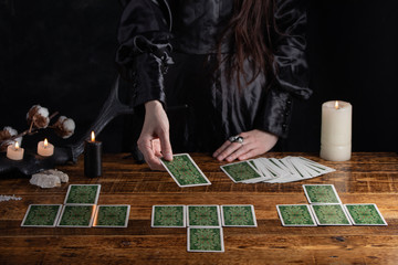 Female tells the future with playing cards. Tarot card concept on the table. Prediction of the...