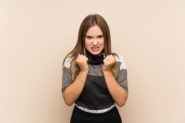 Teenager girl over isolated background frustrated by a bad situation