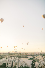 Colorful hot air balloons flying over the valley in Cappadocia, Turkey