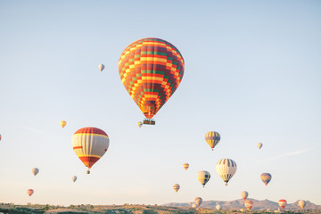 Colorful hot air balloons flying over the valley in Cappadocia, Turkey