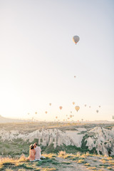 Wedding travel. Honeymoon trip. Couple in love among balloons. Couple in love in Cappadocia. Couple in Turkey. Man and woman traveling. Flying on balloons