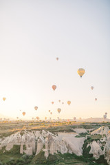 Colorful hot air balloons flying over the valley in Cappadocia, Turkey