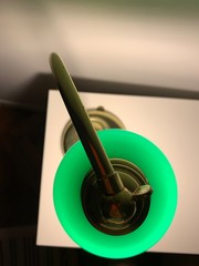 Antique green lamp on the writing desk