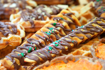 Viennese waffles with chocolate and christmas decorations. Festive edible background