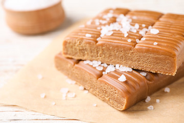 Salted caramel on white wooden table, closeup