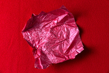 crumpled red candy wrapper