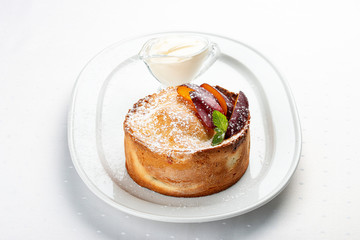 Homemade pie with whole plums from shortbread-almond dough.