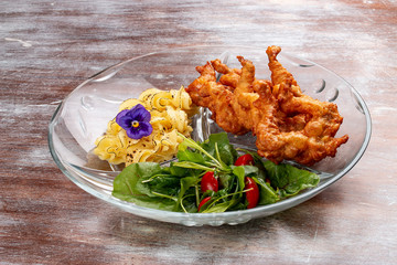 Frog legs crispy with mashed potatoes. Classic retro Russian dish