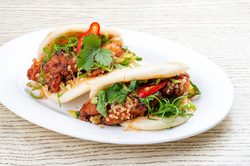 Bao..Rice steamed buns with chicken, spicy herbs and chili peppers. Pan-Asian dish.