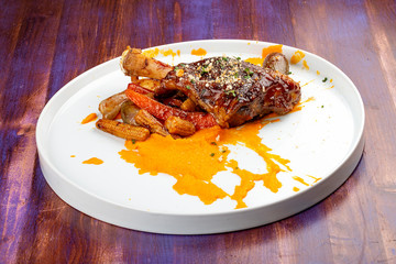Lamb shank with demiglas sauce, carrot puree with caramelized vegetables
