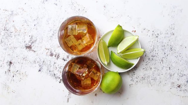 Whiskey sour drink with lemon in glass on stone rustical background