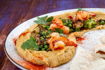 Hummus with shrimp, broccoli, zucchini, eggplant, green peas and homemade tortillas