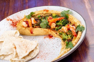 Hummus with shrimp, broccoli, zucchini, eggplant, green peas and homemade tortillas