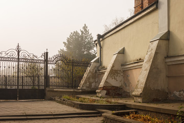 Old town street overlooking the black forged fence. Autumn morning in the city. Ukraine