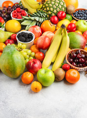 Healthy fruits vegetables background filled with strawberries raspberries oranges plums apples kiwis grapes broccoli cauiliflower mango persimmon pineapple