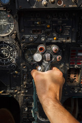 Pilot's hand on the military aircraft control knob. In the cockpit of an old, Soviet military jet. Close-up. Text translation from Russian 