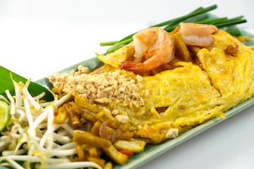 Pad Thai with prawns and eggs and fresh vegetables, isolated on a white background