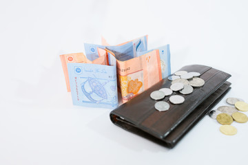 Banknotes and coins on white background
