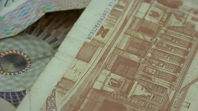 Old banknotes of the European countries Netherlands, Belgium and Denmark, close up in rotation, before the introduction of the Euro