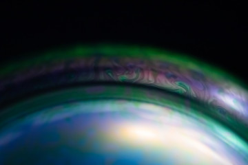 Macro of part of soap sphere on black background