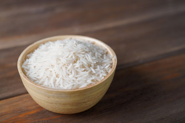 Basmati rice in round bowl on wooden table. Cooking, recipe concept. Close-up, copy space