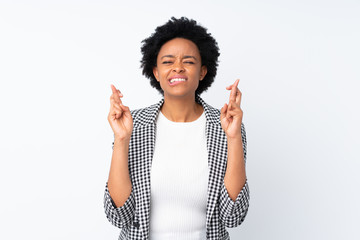 African american woman with blazer over isolated white background with fingers crossing and wishing the best