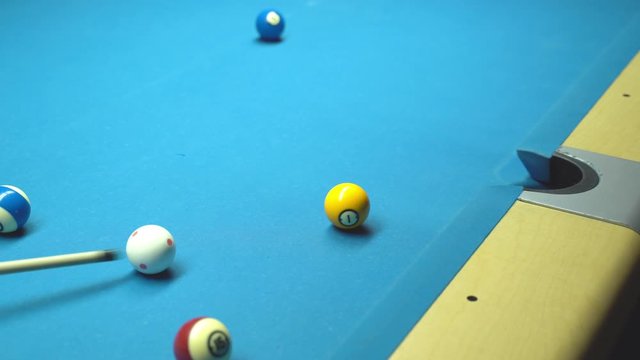 Billiard, missed shot. Blue table, rolling balls.