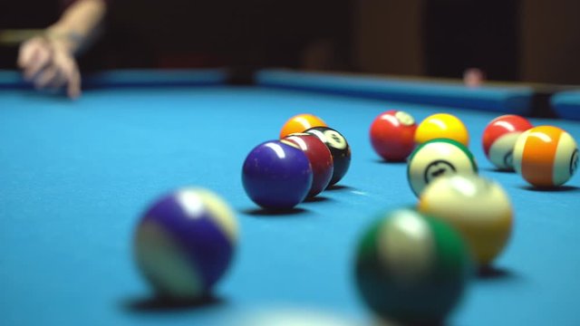 Billiard, kick off. Closeup. Blue table, rolling balls.