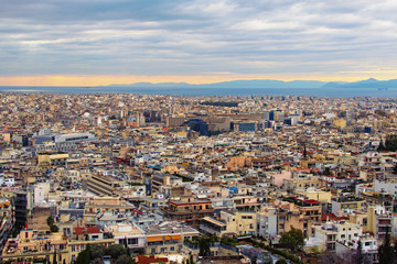 Fototapeta na wymiar Astonishing aerial view over the city of Athens against cloudy sky. Famous touristic place and travel destination in Europe. Greece