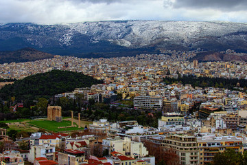 Fototapeta na wymiar Amazing aerial view over the city of Athens against cloudy sky. Famous touristic place and travel destination in Europe. Greece