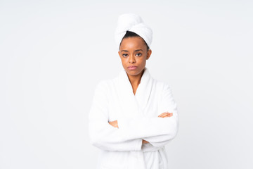 African american woman  in a bathrobe over isolated background keeping arms crossed