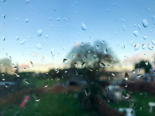 Looking out through a windows which is covered in rain drops.