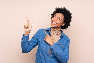 African american woman over isolated background pointing with the index finger a great idea