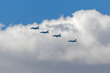 Russian Military jet in the air. Silhouettes of russian fighter aircrafts in the sky. military aircrafts flying together in the sky during airshow