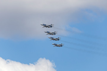 Russian Military jet in the air. Silhouettes of russian fighter aircrafts in the sky. military aircrafts flying together in the sky during airshow