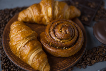 Two croissants and a bun lie on plates