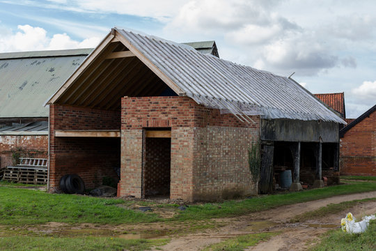 An old barn building that is currently being renovated and converted for a new use and lease of life on a farm
