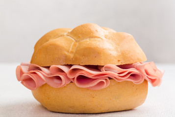 Mortadella sandwich. Mortadella Bologna - a large italian sausage or luncheon  with meat. Tipycal italian bread - La Rosetta. © Olga