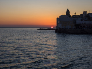 Silhouette of the church and the houses over the sea