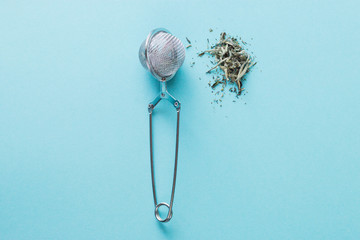Blue background, strainer and poured a handful of tea Bai Hao Yin Zhen Silver needles, useful...