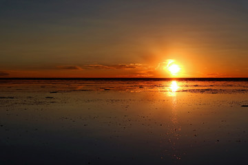 Impressive sunset reflection on the flooded Uyuni Salt Flats of Bolivia, South America