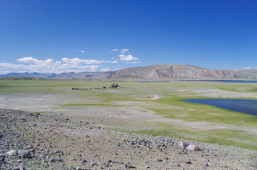 Shore of Khurgan Lake. Turkic memorial structures. Lake lies at foot of the Altai Mountains near...