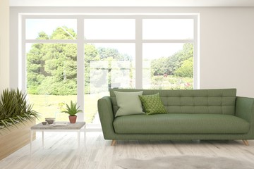 Stylish room in white color with sofa and summer landscape in window. Scandinavian interior design. 3D illustration