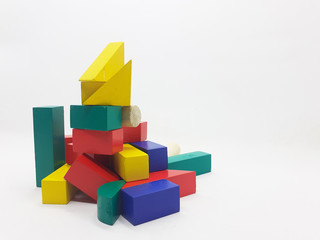 Obraz premium Artistic Handmade Colorful Various Shape Wooden Building Blocks Kid Toys for Playing and Creative Educational Purpose in White Isolated Background