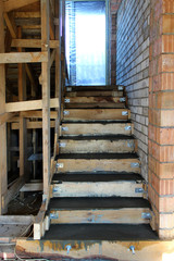 Metal reinforcement and wooden formworks of concrete stairway under construction. Stairs on the...