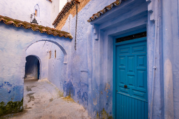 Blue door and alleyway in Chefchaouen, Morocco