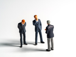 Selective focus of business figure or isolate background. The team leader discusses with the team for finding solution.