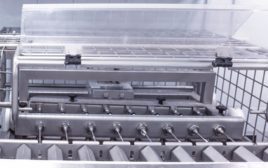 Making and filling custard cakes with cream on a modern automatic line, production of confectionery sweets